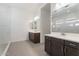 Bathroom featuring double sink vanity, modern fixtures, large mirrors and decorative tile flooring at 1113 E La Mirada Dr, Phoenix, AZ 85042