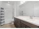 Bathroom featuring wood-look flooring, double sink vanity, and shower over tub with curtain at 1113 E La Mirada Dr, Phoenix, AZ 85042
