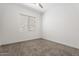 Bright bedroom featuring neutral walls, carpet flooring and window with blinds at 1113 E La Mirada Dr, Phoenix, AZ 85042