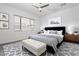 Bright bedroom featuring neutral walls, patterned rug and bedspread, and a modern ceiling fan at 1113 E La Mirada Dr, Phoenix, AZ 85042