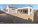 Rear view of a house showcasing a covered patio and landscaping at 1113 E La Mirada Dr, Phoenix, AZ 85042