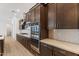Upscale kitchen with stainless steel double oven, light counters, and dark cabinets at 1113 E La Mirada Dr, Phoenix, AZ 85042