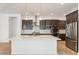 Modern kitchen boasts a large island, stainless steel appliances, and dark wood cabinets at 1113 E La Mirada Dr, Phoenix, AZ 85042