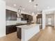 Bright, open kitchen with island, stainless appliances, and wood-look flooring at 1113 E La Mirada Dr, Phoenix, AZ 85042