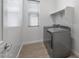 Bright laundry room with washer, dryer, and built-in shelving at 1113 E La Mirada Dr, Phoenix, AZ 85042