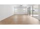 Open concept living room with wood floors and sliding doors providing natural light at 1113 E La Mirada Dr, Phoenix, AZ 85042