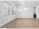 Spacious living room with wood-look floors, large windows, and modern lighting at 1113 E La Mirada Dr, Phoenix, AZ 85042