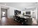 Spacious living room with wood floors, stylish decor, a ceiling fan, and abundant natural light from large windows at 1113 E La Mirada Dr, Phoenix, AZ 85042