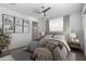 Cozy main bedroom featuring neutral color palette, modern decor, and natural light from a large window at 1113 E La Mirada Dr, Phoenix, AZ 85042