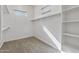 Large walk-in closet with shelving and hanging rods at 1113 E La Mirada Dr, Phoenix, AZ 85042