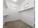 Walk-in closet featuring neutral walls, carpet flooring, windows for natural light and built-in shelving at 1113 E La Mirada Dr, Phoenix, AZ 85042