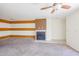 Spacious living room with fireplace and accent wall at 11640 N 51St Ave # 212, Glendale, AZ 85304