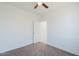 Spacious bedroom with ceiling fan and an adjacent bathroom at 12503 W Jenero Dr, Arizona City, AZ 85123