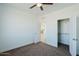 Bedroom with ceiling fan, closet, and view of kitchen at 12503 W Jenero Dr, Arizona City, AZ 85123