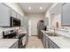 Modern kitchen with gray cabinets, stainless steel appliances, and tile flooring at 15763 N 79Th Dr, Peoria, AZ 85382