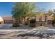 Single-story home with stone accents and landscaped yard at 17679 W Redwood Ln, Goodyear, AZ 85338