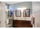 Double-sink bathroom with dark brown vanity and shower at 21925 N 78Th Dr, Peoria, AZ 85383