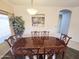 Traditional dining room featuring a wood table, decorative chairs, and modern chandelier at 21925 N 78Th Dr, Peoria, AZ 85383