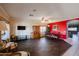 Bright dining area with dark wood floors and red accent wall at 21925 N 78Th Dr, Peoria, AZ 85383