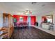 Bright dining area with dark wood floors and red accent wall at 21925 N 78Th Dr, Peoria, AZ 85383