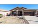 Single-story home with brown garage door and landscaped yard at 21925 N 78Th Dr, Peoria, AZ 85383