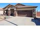 Single-story home with brown garage door and landscaped yard at 21925 N 78Th Dr, Peoria, AZ 85383