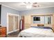 Main bedroom with built-in entertainment center and ceiling fan at 21925 N 78Th Dr, Peoria, AZ 85383