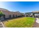 Spacious backyard with grassy lawn and covered patio at 22235 E Munoz Ct, Queen Creek, AZ 85142