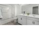 Bathroom with double vanity, shower/tub combo and gray tile floors at 22235 E Munoz Ct, Queen Creek, AZ 85142