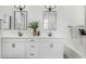 Elegant bathroom with double vanity, white cabinets, and black hardware at 22235 E Munoz Ct, Queen Creek, AZ 85142