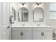 Clean bathroom with double vanity, arched mirrors and modern light fixtures at 22235 E Munoz Ct, Queen Creek, AZ 85142
