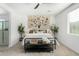 Bright bedroom featuring a large floral tapestry above the bed and a neutral color scheme at 22235 E Munoz Ct, Queen Creek, AZ 85142