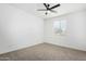 Simple bedroom with a ceiling fan and neutral carpeting at 22235 E Munoz Ct, Queen Creek, AZ 85142