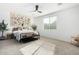 Spacious bedroom with large window, ceiling fan, and neutral color palette at 22235 E Munoz Ct, Queen Creek, AZ 85142