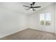 Bright bedroom with ceiling fan, window coverings and carpet at 22235 E Munoz Ct, Queen Creek, AZ 85142