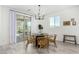 Bright dining room features a round table and wicker chairs, near sliding doors at 22235 E Munoz Ct, Queen Creek, AZ 85142