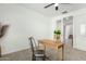 Home office features a desk and chair, carpeted floor, and ceiling fan at 22235 E Munoz Ct, Queen Creek, AZ 85142