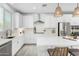 Modern kitchen with white cabinets, quartz countertops, and a gas range at 22235 E Munoz Ct, Queen Creek, AZ 85142