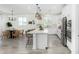 Open concept kitchen with white cabinets, island, and stainless steel appliances at 22235 E Munoz Ct, Queen Creek, AZ 85142