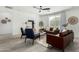 Modern living room with brown leather sofas, blue armchairs, and wood flooring at 22235 E Munoz Ct, Queen Creek, AZ 85142