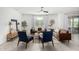 Modern living room with brown leather sofas, blue armchairs, and wood flooring at 22235 E Munoz Ct, Queen Creek, AZ 85142