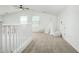 Spacious loft area with a teepee, carpet and white railing at 22235 E Munoz Ct, Queen Creek, AZ 85142