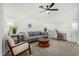 Relaxing loft area with gray couch and wooden coffee table at 22235 E Munoz Ct, Queen Creek, AZ 85142
