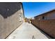 Side yard with concrete paving and access gate at 22235 E Munoz Ct, Queen Creek, AZ 85142