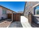 Side yard with a wooden gate and access to the backyard at 22235 E Munoz Ct, Queen Creek, AZ 85142