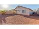 Spacious backyard with gravel, a covered patio, and easy access to the home at 25241 W Park Ave, Buckeye, AZ 85326