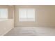 Carpeted bedroom with ample natural light, a large window, and neutral-colored walls at 25241 W Park Ave, Buckeye, AZ 85326