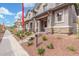 Charming townhome exterior with landscaped front, covered entry, and stone accents for added curb appeal at 2917 N Evergreen St, Buckeye, AZ 85396