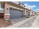 Home featuring a two-car garage with stylish gray doors at 2917 N Evergreen St, Buckeye, AZ 85396