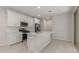 Modern kitchen features white cabinets, stainless steel appliances, and a functional center island with sink at 2917 N Evergreen St, Buckeye, AZ 85396